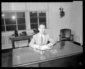 Man with document at desk