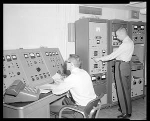 Two men with testing machines