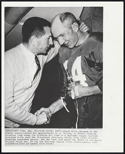 Good Going, YAT! - Coach Allie Sherman of the Giants congratulates his quarterback, Y. A. Tittle, in Yankee Stadium dressing room today for pitching his club to a National League Eastern division title over the Pittsburgh Steelers, 33-17, with three recordbreaking touchdown passes. The New York club meets the Bears in Chicago’s Wrigley Field Dec. 29 for the National League title.
