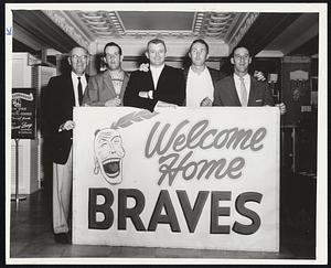 Warren Spahn Is Only Homecoming Brave as these members of the Milwaukee, squad pose with Hotel Kenmore lobby sign. The Braves are here for tonight’s Jimmy Fund game with the Red Sox at Fenway Park. Left to right are Coach John Fitzpatrick, Bob Trowbrigde, Stan Lopata, Don McMahon and Spahn.