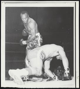 Light heavyweight champion Bob Foster knocks Frank DePaula to the canvas during first round of their bout at Madison Square Garden