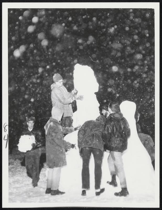 M.I.T. students make snow figures in front of Hayden Library on Memorial Drive