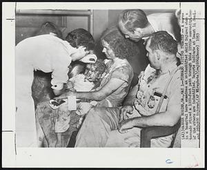 Tornado Victims Treated -- A nurse in a hospital here examines an unidentified child injured when a tornado ripped a 1000-foot path through this little community. None of the others are identified. Reports indicate at least 14 dead and 250-300 injured.