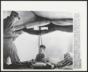 New Jersey Officer on Aid Team in Yugoslavia-Major Ronald D. Massarik of Linden, N.J., consoles a Yugoslav mother and her child in field hospital at Kumanovo, Yugoslavia, today. Major Massarik is a member of U.S. Army medical aid team in the area to aid victims of last Friday's devastating earthquake in Skopje.