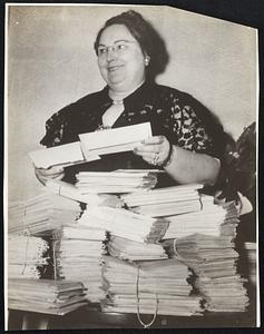 He Put it in Writing-Mrs. Alvin Minor of Dallas, Tex., has received a letter from her husband every day of her nine-year married life. She holds the latest in her collection of more than 3000.