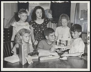 Sailing the Good Ship Book is Kenneth Cambra (front center) one of the many Taunton children who are finding adventures in reading through a unique reading-sailing plan developed by the children's librarian. Watching his progress are (front row) Jean Tatro, (left), and Paul Frago. In rear are Florence Shaw, librarian, Dorothea Stanton, and Pippa Simpson, all of Taunton.