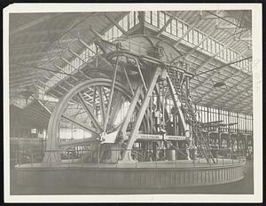 Geo Henry Corliss' 1400 horsepower engine wheel moves all the machinery for the Centennial Exposition at Philadelphia, 1876