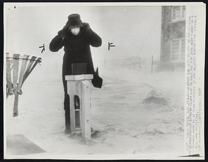 Weather Man Gets Plenty of it-- Federal Meteorologist Kenneth Clark had to hold his hate with both hands in a 50-mile wind as he took readings at the weather bureau here during a blizzard yesterday.