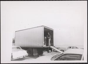Young man standing inside a delivery truck