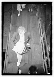 People walking up a gangplank onto a ship