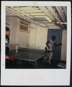 Two boys playing ping pong