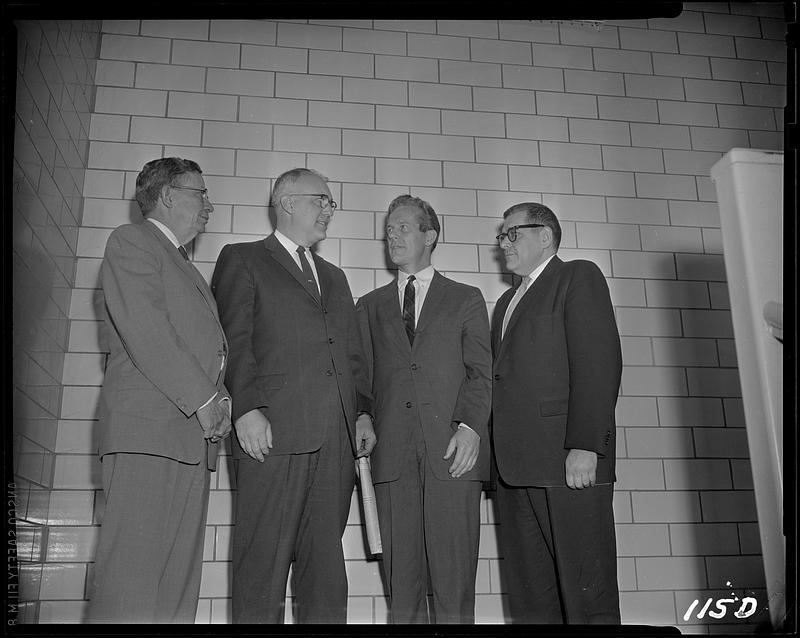 Four men standing together