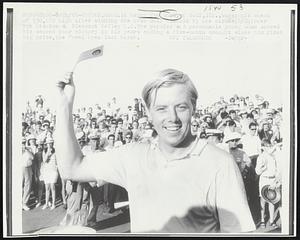 A happy Tom Shaw, of Golf, Ill., waves his check of $30,000 high after winning the Avco Golf Classic by one stroke (8/24) over Bob Stanton at Pleasant Valley C.C. The popular and personable young Shaw scored his second tour victory in six years ending a five-month drought since his first big prize, the Doral Open last March.