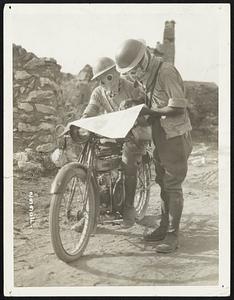 Man or Beast? Masked Dispatch Riders Pick a Safe Road. Masked dispatch riders on the Salonica front well guared from the fumes of Bulgar gas shells, examining a map in order to pick out a safe road back to headquarters.