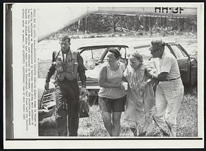 Bay St. Louis, Miss. -- Evacuating Disaster Area -- An elderly woman is helped to a waiting helicopter as persons injured by Hurricane Camille along with patients of the Bay St. Louis Hospital were evacuated to New Orleans. The patients were moved because the violent storm that swept into the Mississippi Gulf Coast left the facility without water or power.