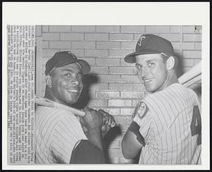 Homer Twins to Victory -- Minnesota Twins catcher Earl Battey (left), and right fielder teammate Bob Allison hold bats and wear smiles in clubhouse after their home runs lead the team to a 6-1 victory over the Detroit Tigers in an American League game last night in Twin Cities. Allison blasted two homers, one in fourth inning and the other in eight. Battey hit one in eight inning right behind Allison's. All three were with no one on base. It was Battey's 16th of the year. Allison, who leads league, got his 18th and 19th. He also is league leader in RBI's with 52 and runs scored with 53.