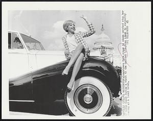 Songstress Edie Adams is shown perched atop her 52 Rolls Royce during a visit to the Capitol 5/14. Miss Adams is currently pearing at a local hotel.