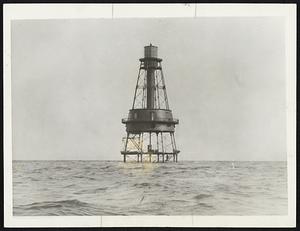 Where S.S. Dixie is aground. A view of Carysfort Reef off the coast of Florida near where the S.S. Dixie with 350 or more persons aboard is aground in heavy seas. The lighthouse is about 10 miles off shore and the depth of the water over the underwater barrier of coral rock is about one foot in the immediate vicinity of the lighthouse.