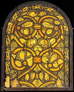 Gothic shaped window, urvilinear bands and leaves motif in shades of yellow