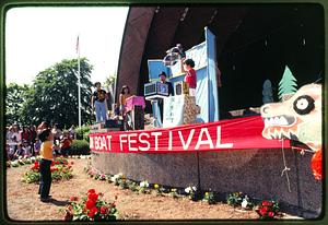 Boston: A child stands in front of the Hatch Shell during the annual Dragon Boat Fest - 1981