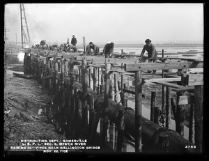 Distribution Department, Low Service Pipe Lines, Section 5, Mystic River, raising 36-inch pipes near Wellington Bridge, Somerville, Mass., Nov. 22, 1902