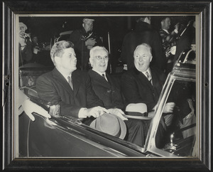 John F. Kennedy riding in car with John W. McCormack and John F. Collins