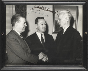 John W. McCormack shaking hands with two other men