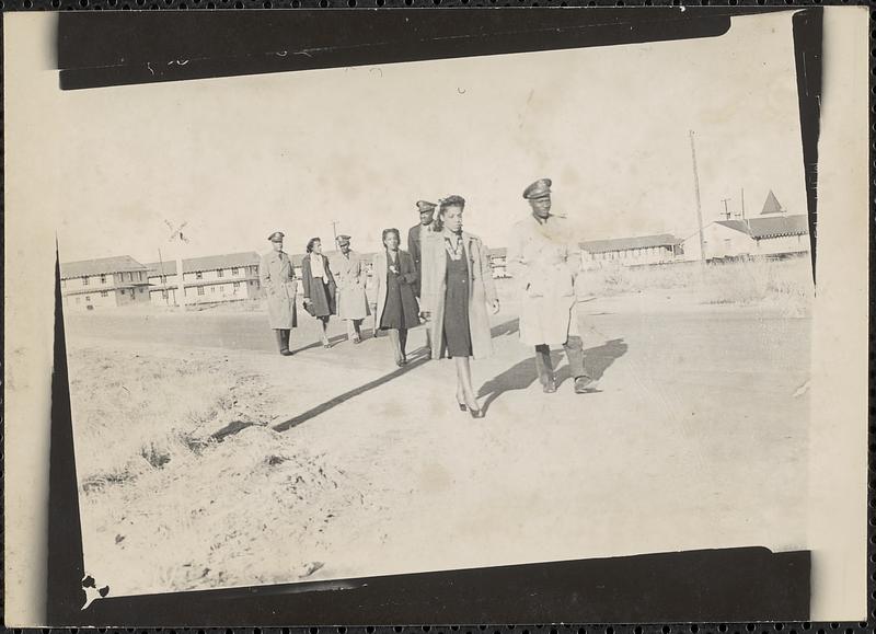 Four men and three women walk down the road