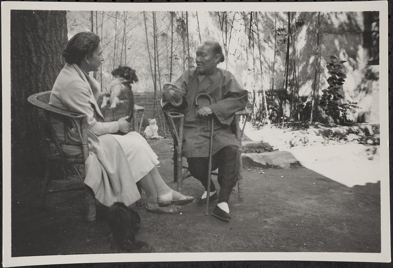 Ida Pruitt sitting with woman and two dogs and a cat