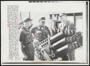 Newest Viet Cong Weapon Captured--"Good God Almighty," said Gen. Creighton W. Abrams, Jr., center, commander of U.S. Forces in Vietnam, when he inspected this 12-tube rocket launcher found among tons of supplies hidden by Viet Cong near Saigon. It is one of the newest weapons in the enemy arsenal. With Gen. Abrams are Adm. John S. McCain, left, commander U.S. forces in the Pacific, and Col. Ira A. Hunt, commander of First Brigade of the 9th Infantry Division. The launcher fires 107 mm rockets.