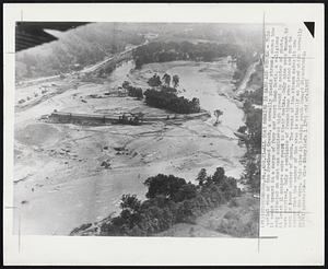 That Remains is Sand and Rubble- This aerial view of the Brodhead Creek, a normally placid stream, shows how it swept upward in a surge of fury and swept Camp Davis, a religious camp situated on what was considered high ground in center of photo, At least 31 campers were swept to their deaths. Only nine were known to have survived. Only a semblance of foundations even stood and can be seen in lower center of photo. The route of the stream makes it now appear that the center of the area is actually an island which normally wasn't the case. This view is looking south toward Stroudsburg.
