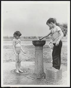 Squirt Squirts Squirt-- A familiar hot weather pastime is indulged in by Joseph Burnett, 8, and Claire Hogan, 9, at the fountain on Columbia road, South Boston.