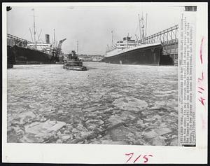 Chugging Its Way Through Ice-Filled Hudson -- A lone tug makes its way through the ice-filled Hudson River alongside the Samaria (left) and the Brittanic between Piers 90 and 92 here today. The New Jersey shore looms in background.