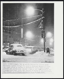 Waterville, Me. - Motorists Battle Through Snow - Motorist plowed though the snow in downtown Waterville Sunday night after 14 inches of wind-driven light snow clogged streets and pushed snow removal crews to the light. Streets and highways were kept open, but Bangor, 57 miles to the northeast, was brought to a virtual standstill by a 31 inch fall.