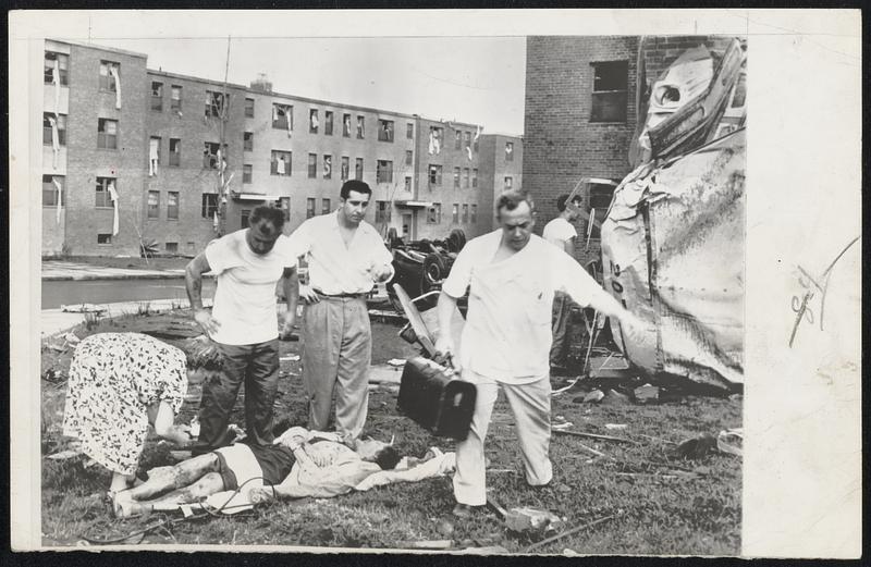 Worcester Injured Aided - Doctors and civilians go from patient to patient at tornado-struck area in government veterans housing project.