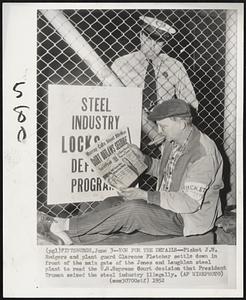 Now for the Details -- Picket J. W. Rodgers and plant guard Clarence Fletcher settle down in front of the main gate of the Jones and Laughlin steel plant to read the U.S. Supreme Court decision that President Truman seized the steel industry illegally.