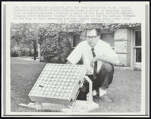 Dr. James E. Faller of Wesleyan University in Middletown, Conn., displays a model of his brain child, the "Laser-Ranging Retro-Reflector Package". This was one of the two devices deployed on the moon by Neil Armstrong and Buzz Aldrin during their lunar walk.