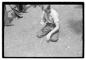 A boy looking down at a knife