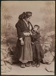 Studio portrait of woman and child in traditional Greek dress