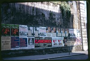 Posters on retaining wall, Rome, Italy