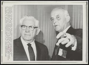 Steel Talks Open-- R. Conrad Cooper, right, chief negotiator for 11 major steel producers, gestures in direction of conference table in New York today as he stands with I.W. Abel, president of the AFL-CIO United Steelworkers of America. The contract talks between the union and the steel companies opened in the most optimistic atmosphere in years.