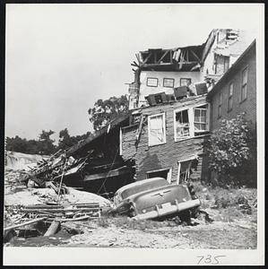 Fellows Hall Wrecked- The Odd Fellows Hall of Putnam Conn., was completely wrecked by the waters of the Quinebaug River as it overflowed its banks during New England's worst recorded rainfall.