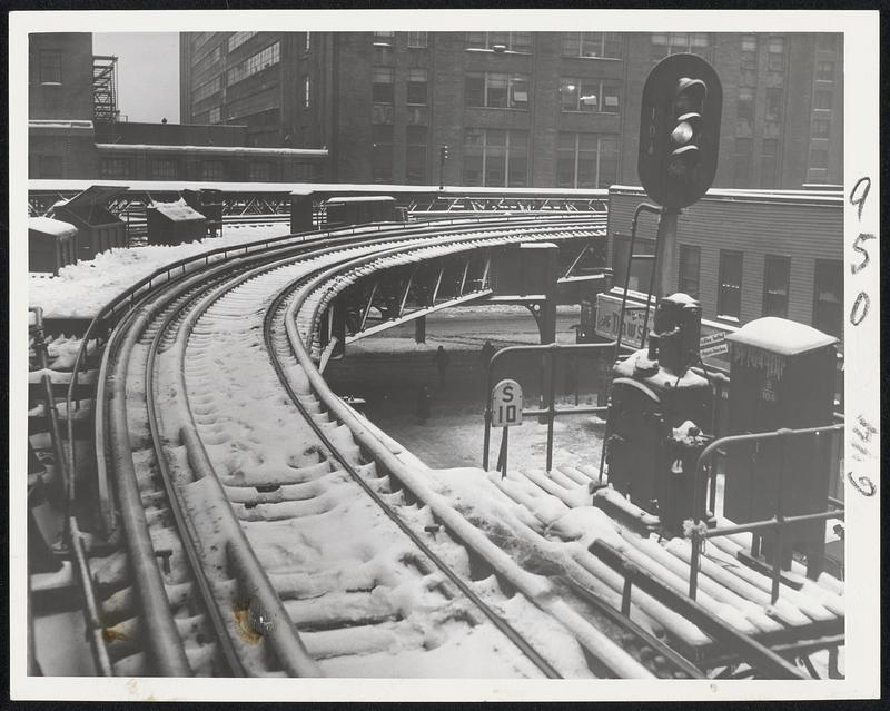 Cause of the Delay-This photo shows the ice-glazed tracks and third rail which put the Everett-Forest Hills MTA line out of operation for hours today. An estimated 100,000 commuters were delayed by this and other tieups. The photo was taken at the North Station upper level.