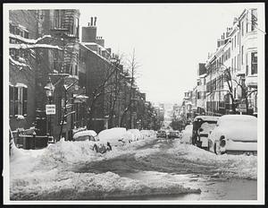 Snowbound Beacon Hill -- This shows the long view of Chestnut street with cars parked on both sides so plows could open only a center lane.