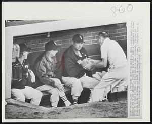 Pitcher Gets Treatment-In fifth inning Early Wynn, Chicago White Sox pitcher, received hot water bottle treatment on arm--which stiffened so that in 8th inning he was replaced. Trainer Ed Froelich works on Wynn. At left is Manager Al Lopez. Alongside Wynn is Coach Johnny Cooney.