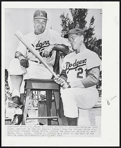 Carey Reports to Dodgers--Infielder Andy Carey, obtained by the Los Angeles Dodgers from the Chicago White Sox, talks with manager Walter Alston during the practice session at Vero Beach, Fla., today. Alston is sitting on a stool at the rear of the batting cage.