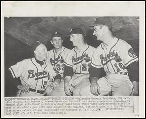 Bravesl Pennant Pitchers--Milwaukee Manager Fred Haney (L) talks with pitchers Lew Burdette, Warren Spahn and Bob Buhl to discuss strategy on down-to-wire pennant fight with Brooklyn Dodgers. Haney said today these three hurlers would start the rest of the club's game with Gene Conley in the bullpen. Tonight's game with the Pittsburgh Pirates was rained out and rescheduled for tomorrow at 1:30 p.m., Est.