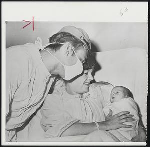 Actor Nick Adams, wearing hat he uses for the starring role in "The Rebel" on TV, leans over Carol for a look at their new son, Jeb Stuart Adams, at Hollywood Presbyterian Hospital.