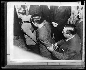 Bruno Richard Hauptmann being led by a police officer