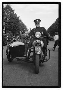 A police officer on a motorcycle with a sidecar